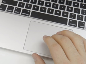 Hand using a laptop touch pad